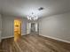 Open bedroom with luxury vinyl flooring, shuttered windows, and contemporary lighting at 1016 Eaglewood Dr, Las Vegas, NV 89144