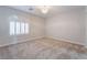 Bedroom featuring plush carpet, shuttered window, and elegant chandelier at 1016 Eaglewood Dr, Las Vegas, NV 89144