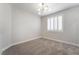 Bedroom featuring neutral paint, plush carpet, contemporary lighting, and shuttered window at 1016 Eaglewood Dr, Las Vegas, NV 89144