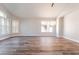 Bright open-concept dining room with hardwood floors, a modern chandelier, and ample space at 1016 Eaglewood Dr, Las Vegas, NV 89144