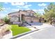 Charming two-story home featuring a three-car garage, manicured lawn, and a welcoming entrance at 1016 Eaglewood Dr, Las Vegas, NV 89144