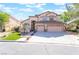 Charming two-story home featuring a three-car garage, manicured lawn, and a welcoming entrance at 1016 Eaglewood Dr, Las Vegas, NV 89144