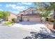 Charming two-story home featuring a three-car garage, manicured lawn, and a welcoming entrance at 1016 Eaglewood Dr, Las Vegas, NV 89144