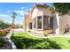 Backyard features turf, manicured landscaping, a pool, and a balcony at 1016 Eaglewood Dr, Las Vegas, NV 89144