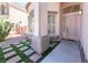 Inviting front entrance featuring a decorative door, manicured landscaping, and modern stonework at 1016 Eaglewood Dr, Las Vegas, NV 89144