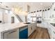 Bright kitchen island featuring a sink, stainless steel appliances, and seating, perfect for entertaining at 1016 Eaglewood Dr, Las Vegas, NV 89144