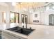 Kitchen island featuring a modern sink and faucet, with views of the open concept floorplan at 1016 Eaglewood Dr, Las Vegas, NV 89144