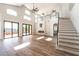 Spacious living area featuring high ceilings, a fireplace, modern railing and a wall of glass doors at 1016 Eaglewood Dr, Las Vegas, NV 89144