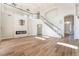 Bright living space with hardwood floors, high ceilings, a modern fireplace, and staircase at 1016 Eaglewood Dr, Las Vegas, NV 89144