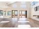 Spacious living room boasts high ceilings, fireplace feature wall, and sliding glass doors to the backyard at 1016 Eaglewood Dr, Las Vegas, NV 89144
