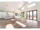 Bright living room features high ceilings, sliding glass doors, and an open floor plan to the modern kitchen at 1016 Eaglewood Dr, Las Vegas, NV 89144