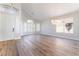 Bright, open-concept living space with hardwood floors, a modern chandelier, and ample natural light at 1016 Eaglewood Dr, Las Vegas, NV 89144