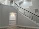 Staircase with glass railings leading to the second floor of the home at 1016 Eaglewood Dr, Las Vegas, NV 89144