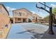 Expansive backyard featuring a basketball court, patio seating, exterior home, and hammock at 10329 Walworth Ave, Las Vegas, NV 89166