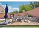 Inviting backyard patio featuring a fire pit, comfortable seating, and lush landscaping for outdoor relaxation at 10329 Walworth Ave, Las Vegas, NV 89166