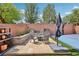 Cozy backyard featuring a basketball court, seating area, planters, decor, and lush trees at 10329 Walworth Ave, Las Vegas, NV 89166