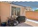 Outdoor kitchen area with a striped awning and cooking appliances on a brick patio at 10329 Walworth Ave, Las Vegas, NV 89166