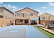 Spacious backyard featuring a basketball court, patio seating, exterior home, and lush landscaping at 10329 Walworth Ave, Las Vegas, NV 89166