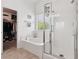 Bright bathroom showcasing a soaking tub, glass enclosed shower, and walk-in closet at 10329 Walworth Ave, Las Vegas, NV 89166