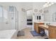Bright bathroom with a soaking tub, glass enclosed shower, and double sink vanity at 10329 Walworth Ave, Las Vegas, NV 89166