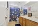 Bathroom featuring dual sinks, patterned shower curtain, and modern fixtures at 10329 Walworth Ave, Las Vegas, NV 89166