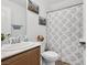 Bright bathroom features a sink with modern fixtures and shower with patterned curtain at 10329 Walworth Ave, Las Vegas, NV 89166