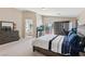 Expansive primary bedroom showcasing a seating area, workspace and an adjacent bathroom at 10329 Walworth Ave, Las Vegas, NV 89166