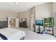 Airy primary bedroom with a work area, plants and an open doorway to the Primary bathroom at 10329 Walworth Ave, Las Vegas, NV 89166