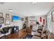 Versatile bonus room showcasing exercise equipment, comfortable seating, and natural light at 10329 Walworth Ave, Las Vegas, NV 89166