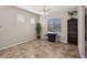 Bright dining area with tile floors, a chandelier, and a view of the backyard at 10329 Walworth Ave, Las Vegas, NV 89166