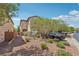 Two story home with desert landscaping and a driveway with parking at 10329 Walworth Ave, Las Vegas, NV 89166