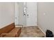 Foyer with tile flooring, a wooden bench and a view of the front door at 10329 Walworth Ave, Las Vegas, NV 89166