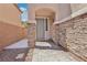 Front entrance with stone columns, stone wall and brick paver walkway at 10329 Walworth Ave, Las Vegas, NV 89166