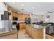Bright and open kitchen featuring granite countertops, stainless steel appliances, and an island with bar seating at 10329 Walworth Ave, Las Vegas, NV 89166