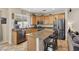 A well-lit kitchen with granite countertops, oak cabinets and stainless steel appliances at 10329 Walworth Ave, Las Vegas, NV 89166