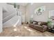 Bright living room featuring high ceilings, tile floors, and a staircase leading to the second floor at 10329 Walworth Ave, Las Vegas, NV 89166