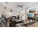 Comfortable living room featuring a ceiling fan, multiple sofas, and a decorative fireplace at 10329 Walworth Ave, Las Vegas, NV 89166