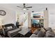 Well-decorated living room with hardwood floors, ceiling fan, fireplace, and staircase access at 10329 Walworth Ave, Las Vegas, NV 89166