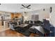 Open concept living room featuring a kitchen, hardwood floors, comfortable sofas, and modern decor at 10329 Walworth Ave, Las Vegas, NV 89166