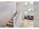 Carpeted staircase with white railings and a view of the living area at 10329 Walworth Ave, Las Vegas, NV 89166
