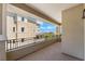 Spacious covered balcony featuring decorative railings and views of the surrounding buildings at 128 Los Cabos Dr # 301, Las Vegas, NV 89144
