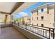 Expansive balcony with wrought iron railings and a picturesque view of the neighborhood at 128 Los Cabos Dr # 301, Las Vegas, NV 89144