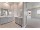 Bright bathroom featuring dual sinks with grey cabinets and modern fixtures at 128 Los Cabos Dr # 301, Las Vegas, NV 89144