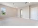 Bright bedroom with neutral carpet, white trim, and a sun-filled window at 128 Los Cabos Dr # 301, Las Vegas, NV 89144