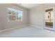 Cozy bedroom with large window offering a view, neutral carpet and access to a balcony at 128 Los Cabos Dr # 301, Las Vegas, NV 89144