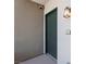 Condo entrance featuring a well-lit wall sconce and the unit number on the right at 128 Los Cabos Dr # 301, Las Vegas, NV 89144