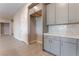 Bright kitchen with gray cabinets, white backsplash, and modern countertops at 128 Los Cabos Dr # 301, Las Vegas, NV 89144