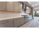 Contemporary kitchen with stainless steel appliances, white countertops, and herringbone backsplash at 128 Los Cabos Dr # 301, Las Vegas, NV 89144