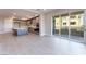 Modern kitchen with a large island and stainless steel appliances, with sliding glass doors to the balcony at 128 Los Cabos Dr # 301, Las Vegas, NV 89144