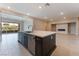 Open kitchen featuring an island with a sink and stainless steel appliances at 128 Los Cabos Dr # 301, Las Vegas, NV 89144